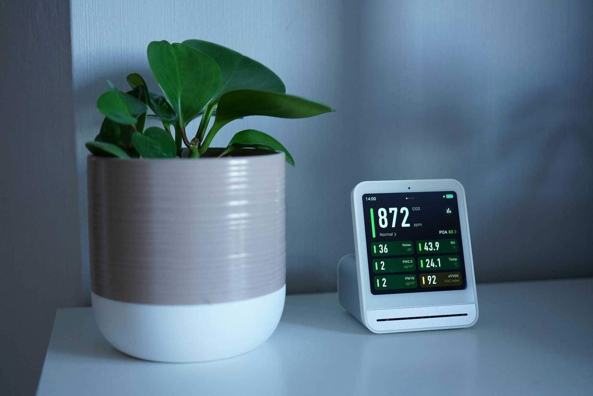 Photo of a smart thermostat on a end table