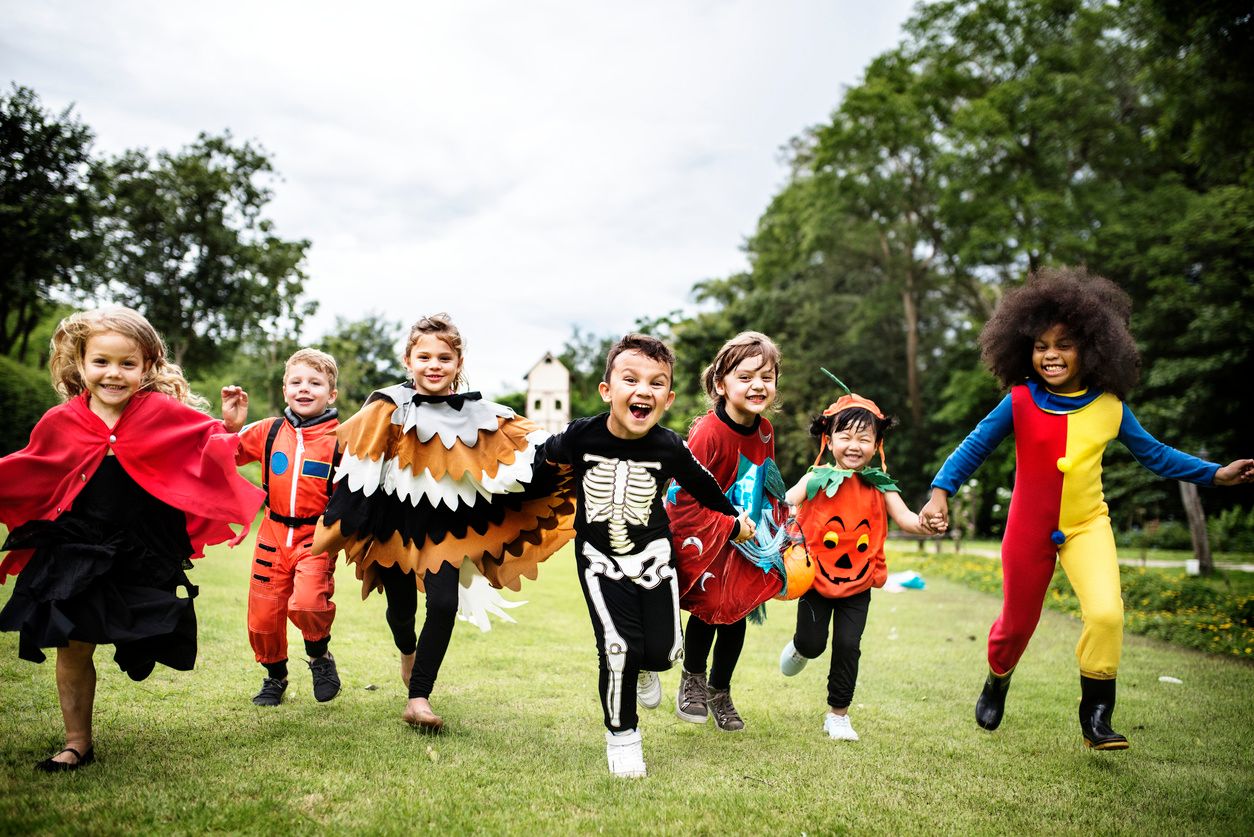 photo of kids running with halloween costumes on.