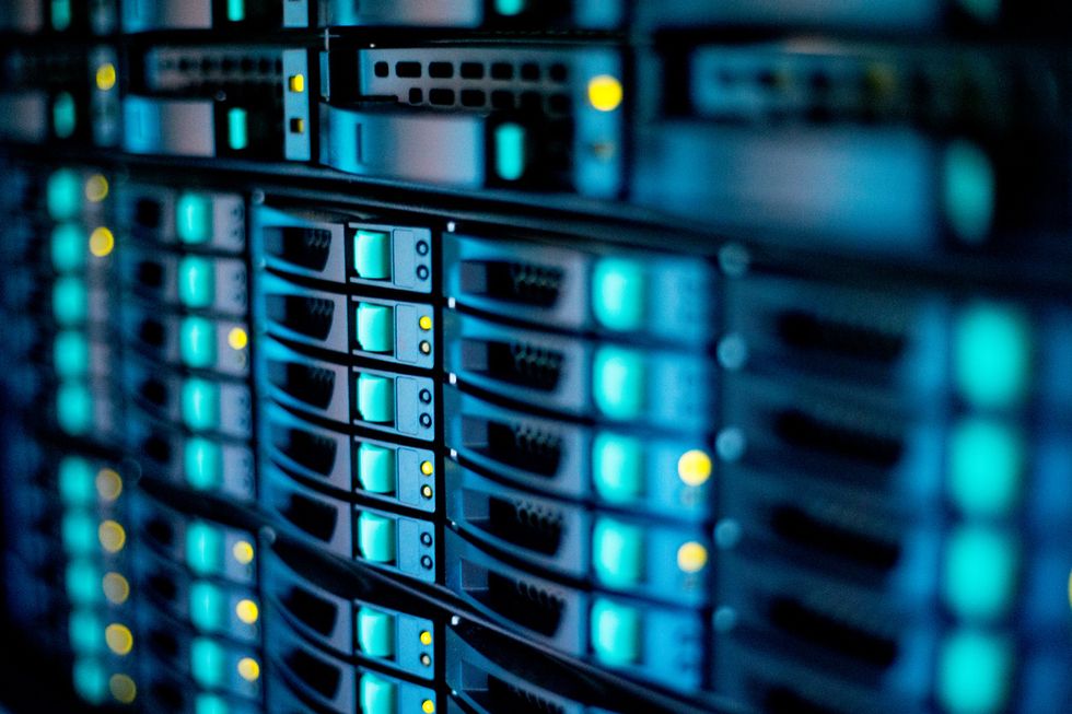 A bank of servers with blue, yellow and green lights