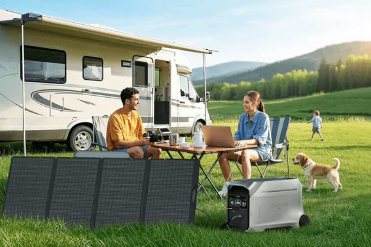 a couple sitting at a campsite next to an RV and ecoflow power station and portable solar panel