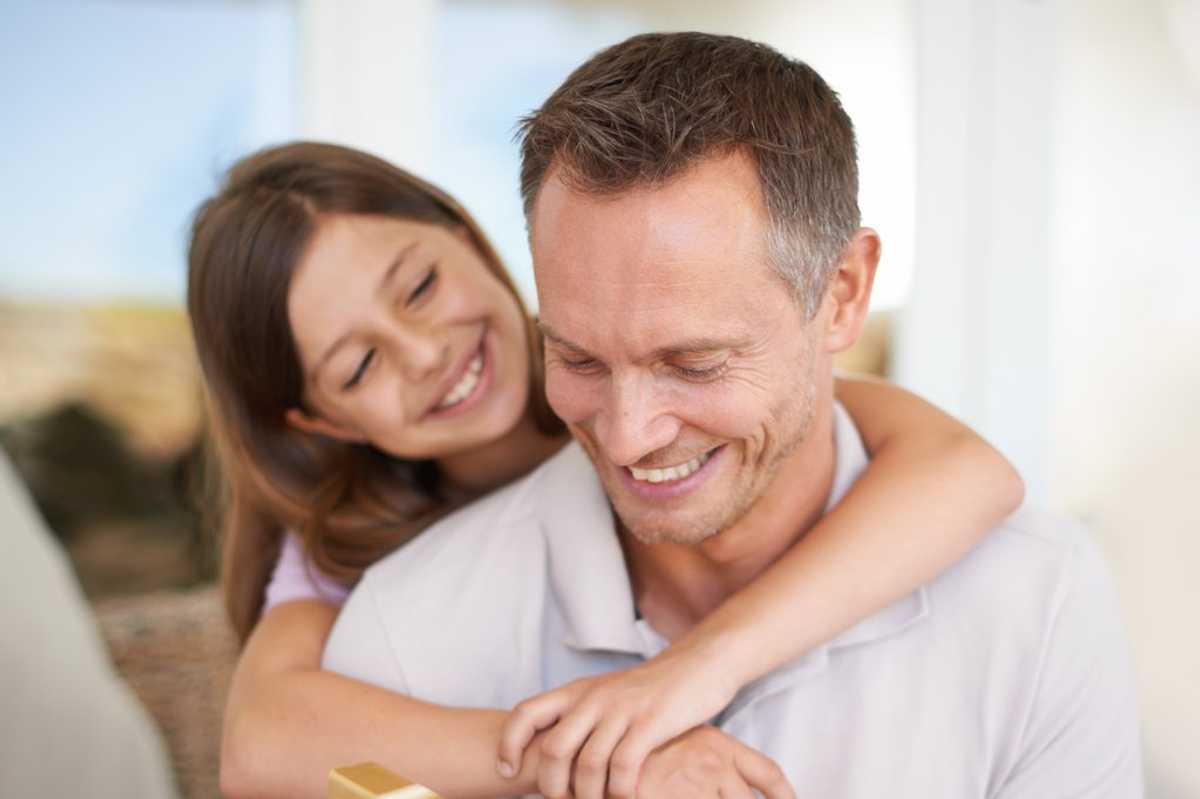a dad opening a gift from his daughter