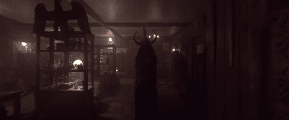 A dimly lit room with lots of small figures in glass cases