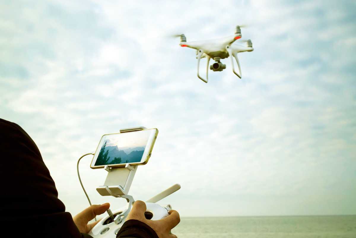 A drone pilot flying a drone