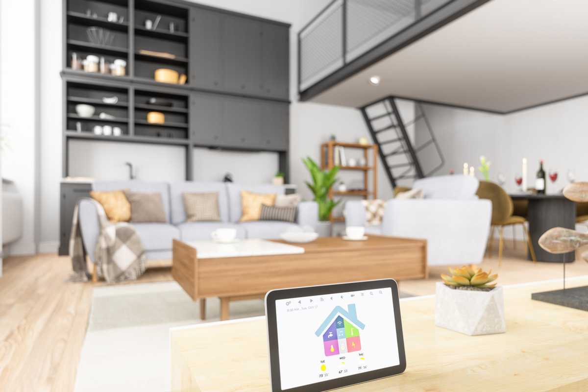 A home with a security system displayed on a tablet