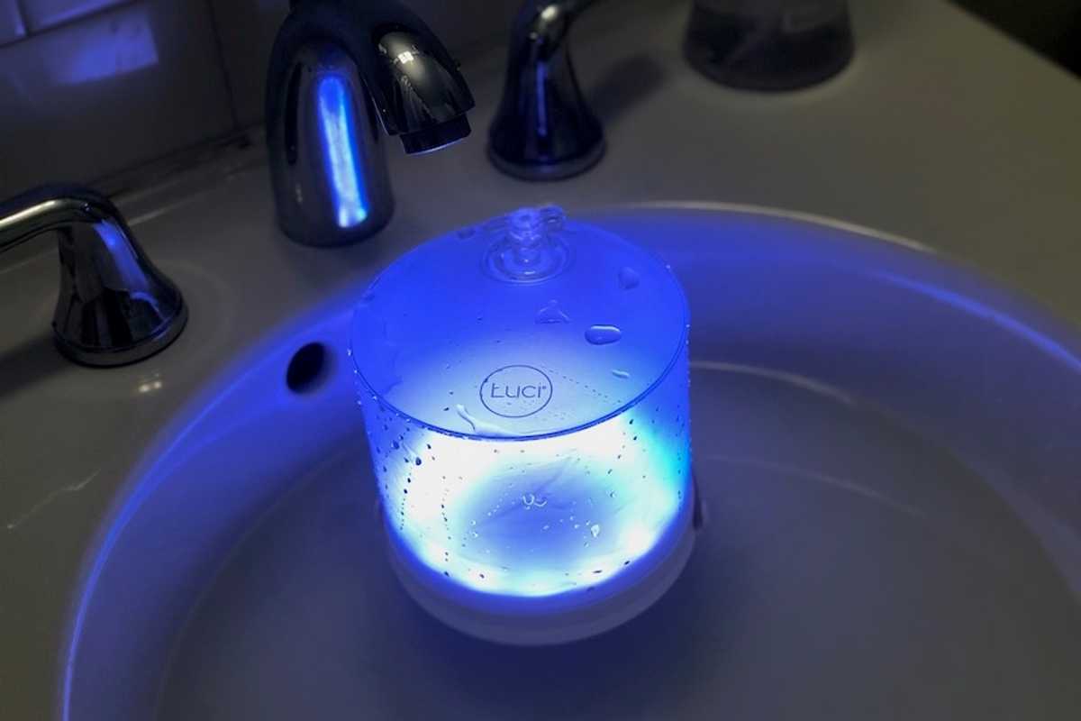 A Luci Connect solar-powered lantern floating in water