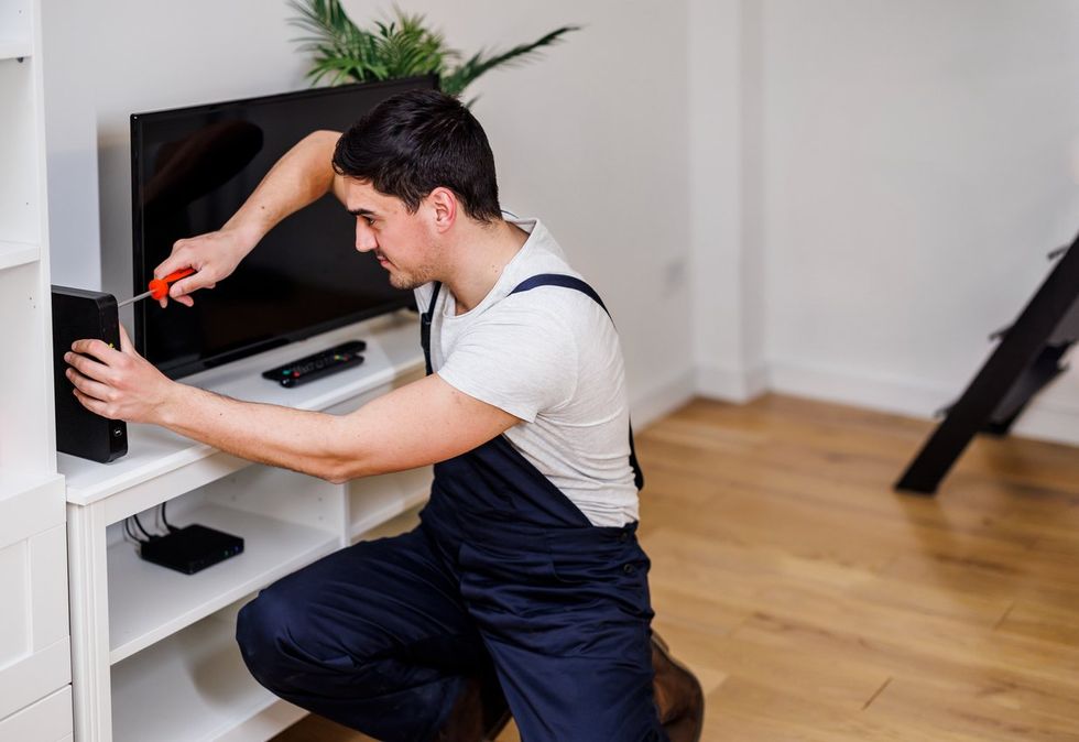 a man installing a Wi-Fi router