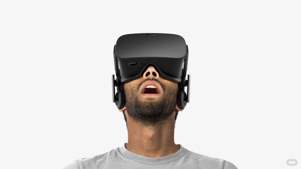 a man wearing VR headset looking up in the air photo