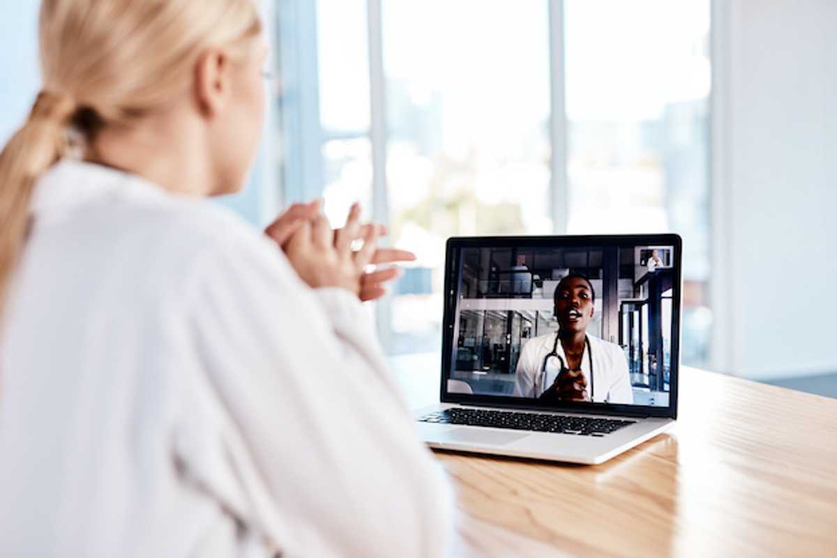 A patient talking to a doctor on a computer
