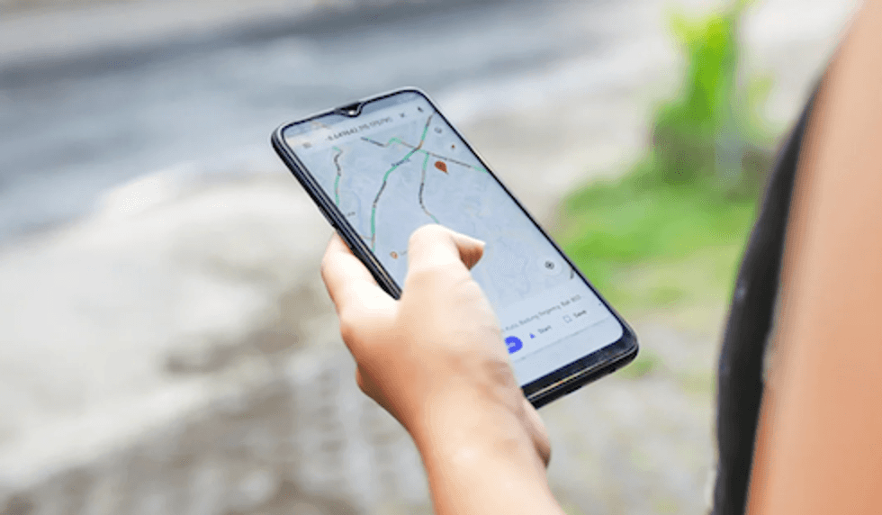 A person holding a smartphone outside