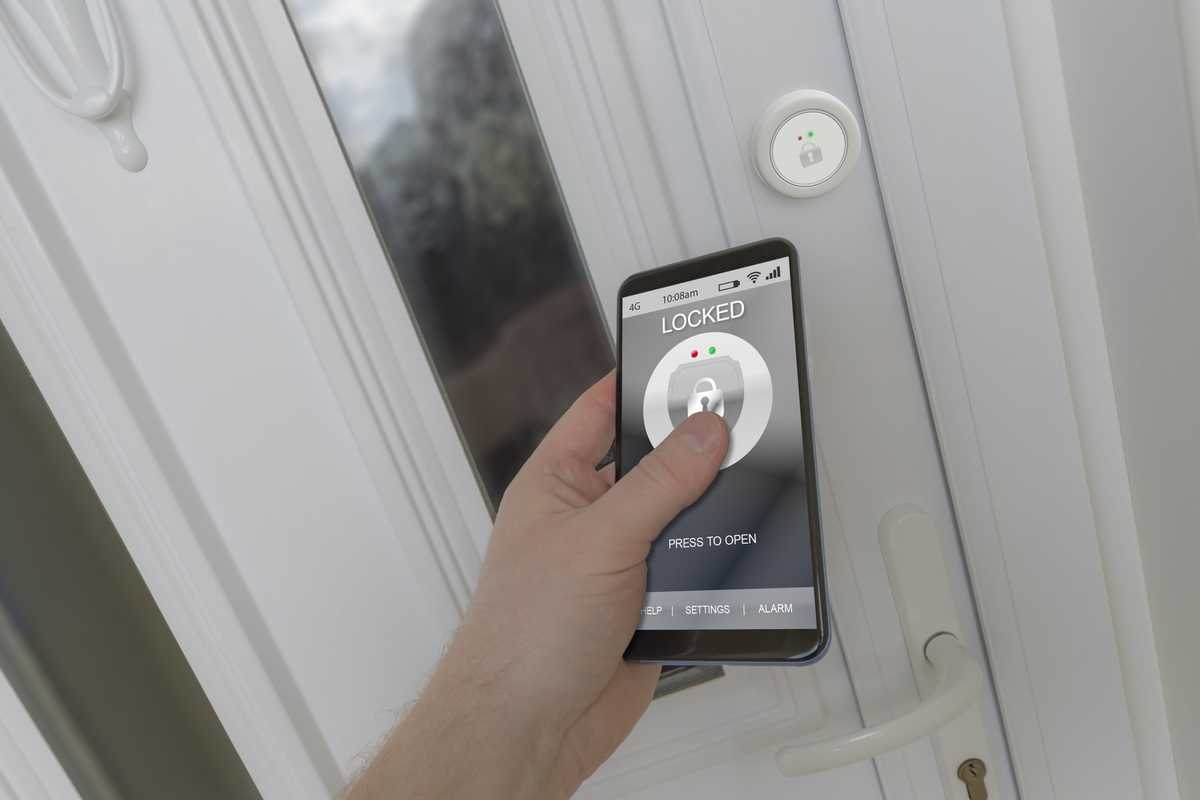 a person using smartphone and app to unlock a smart door lock.