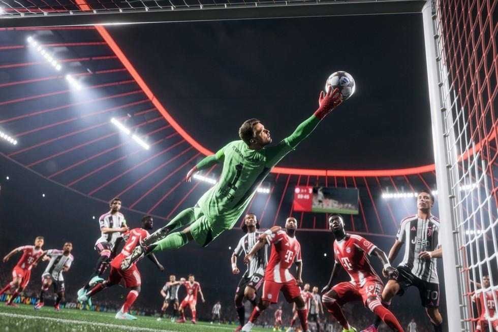 a ph oto of a goalie making a save in a soccer game.
