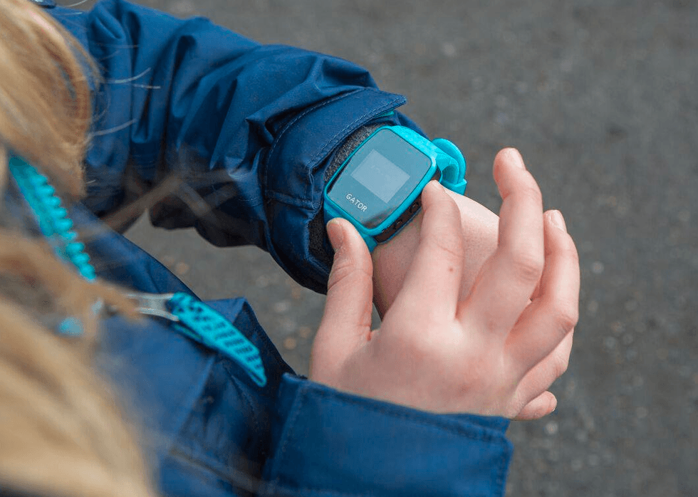 a ph0oto of a child wearting a smartwatch made for children