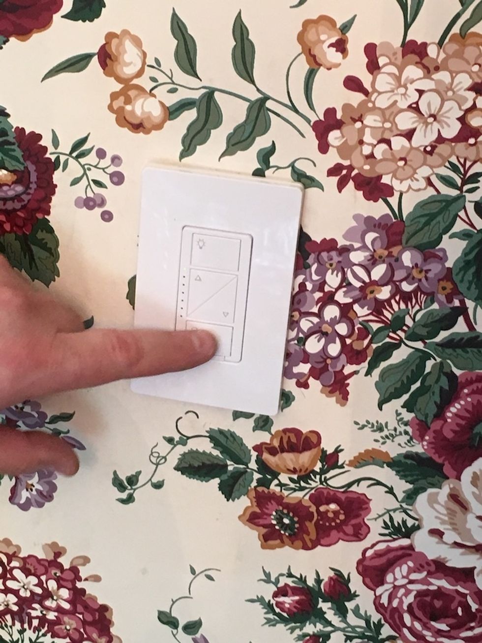 A photo fo Lutron Caseta smart switch installed on a wall.