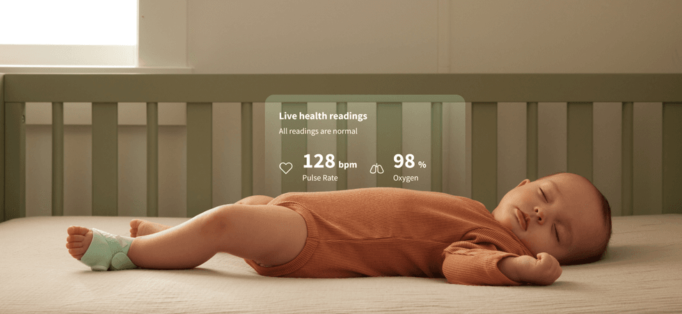 a photo of a baby sleeping with Owlet FDA Cleared Dream Sock and graphics showing