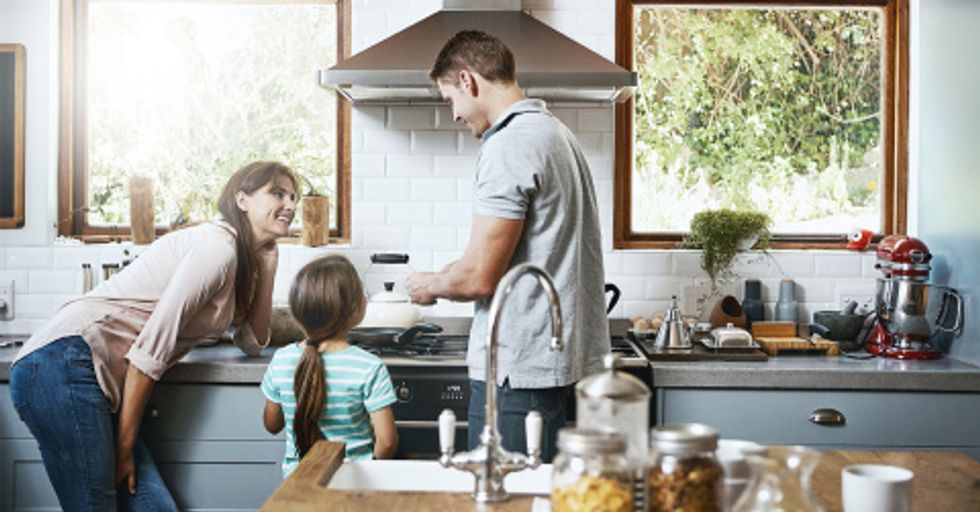 A photo of a family in front of a connected oven in their home