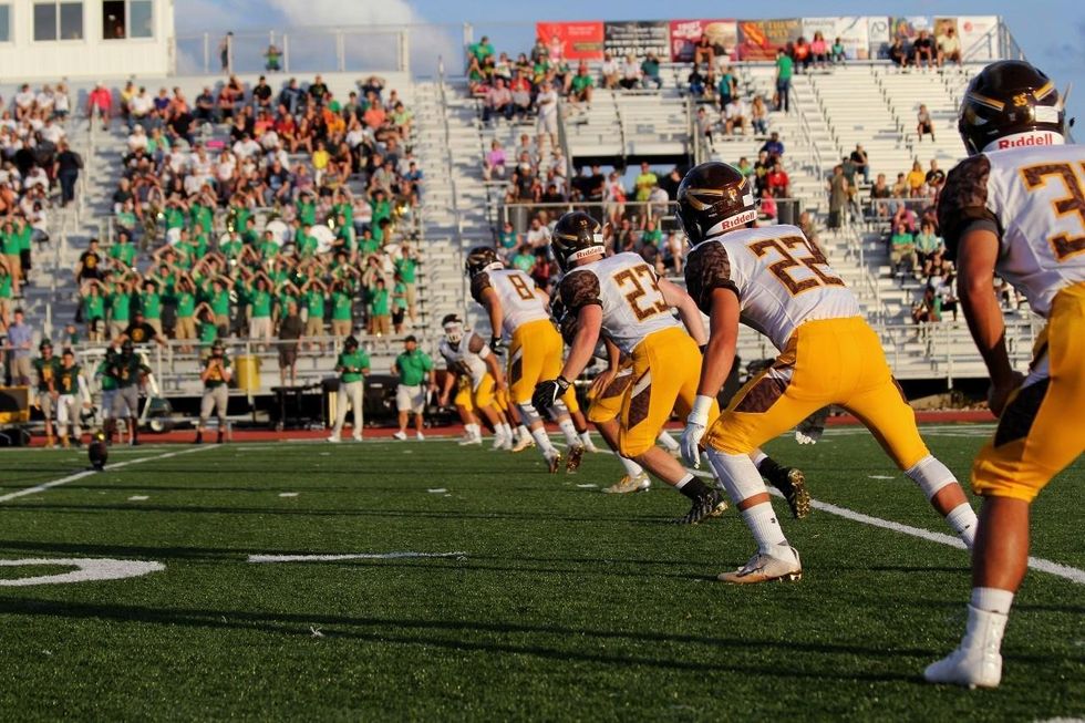 a photo of a football game showing the kickoff.