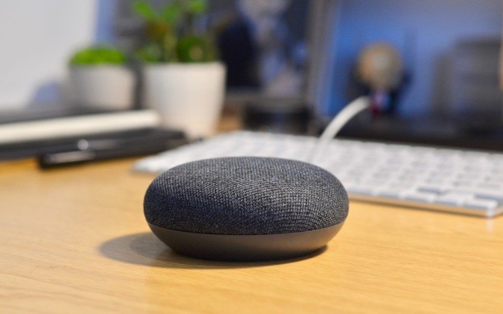 A photo of a Google Home Mini which is designed to wake up when it hears its name