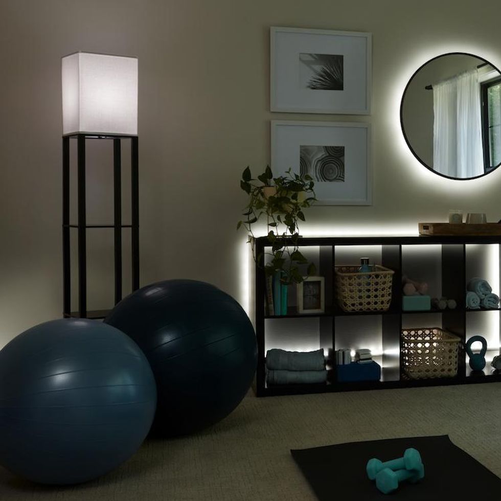 A photo of a in-home gym with Cync Reveal smart lights.