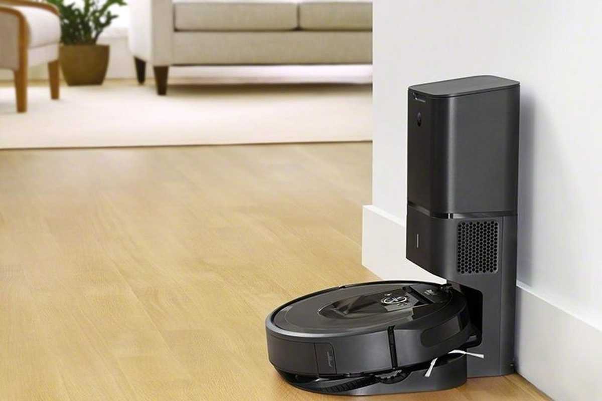 a photo of a iRobot roomba charging on a self-emptying station