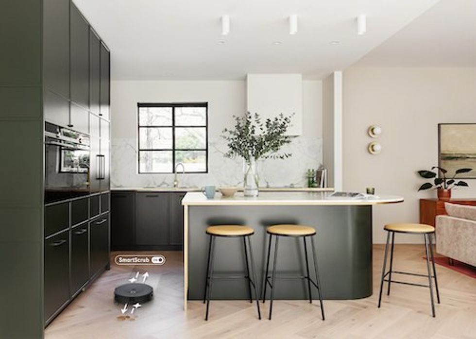a photo of a kitchen with Roomba Combo 10 Max cleaning the floors.