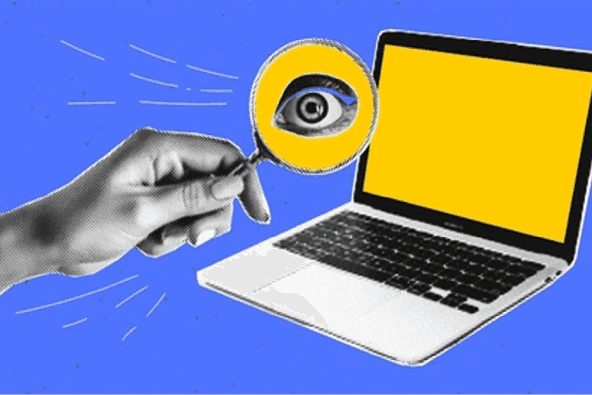 a photo of a laptop and a hand holding a magnifying glass with an eye showing.