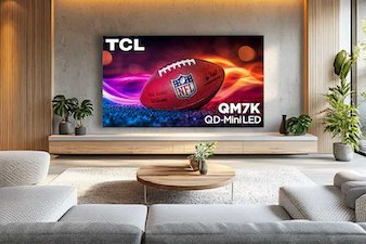 a photo of a living room with TCL QM7K Smart TV on the wall.