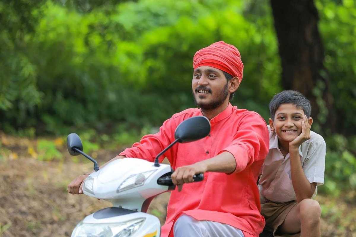 a photo of a man and boy riding a scooter
