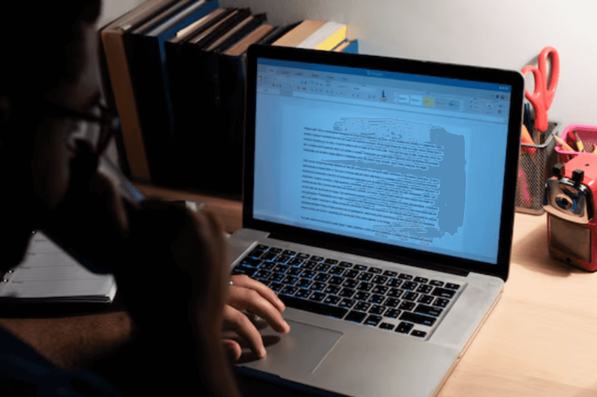 a photo of a man drinking coffee while working on a laptop with AI tool.