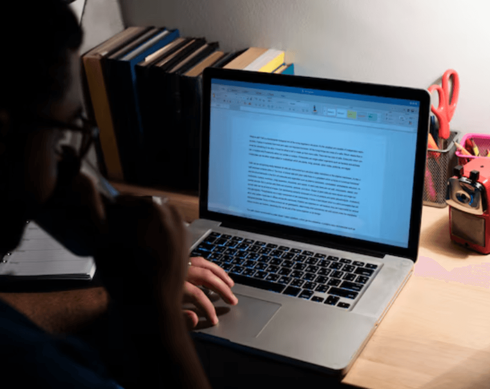 a photo of a man drinking coffee while working on a laptop with AI tool.