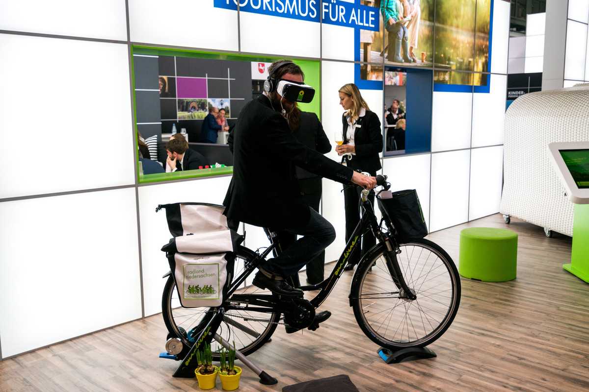 a photo of a man on a bike wearing VR headset