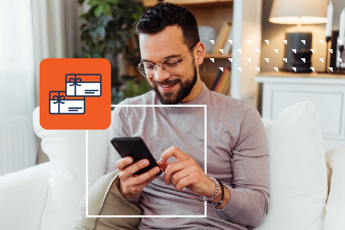 a photo of a man using his smartphone to send a digital gift card