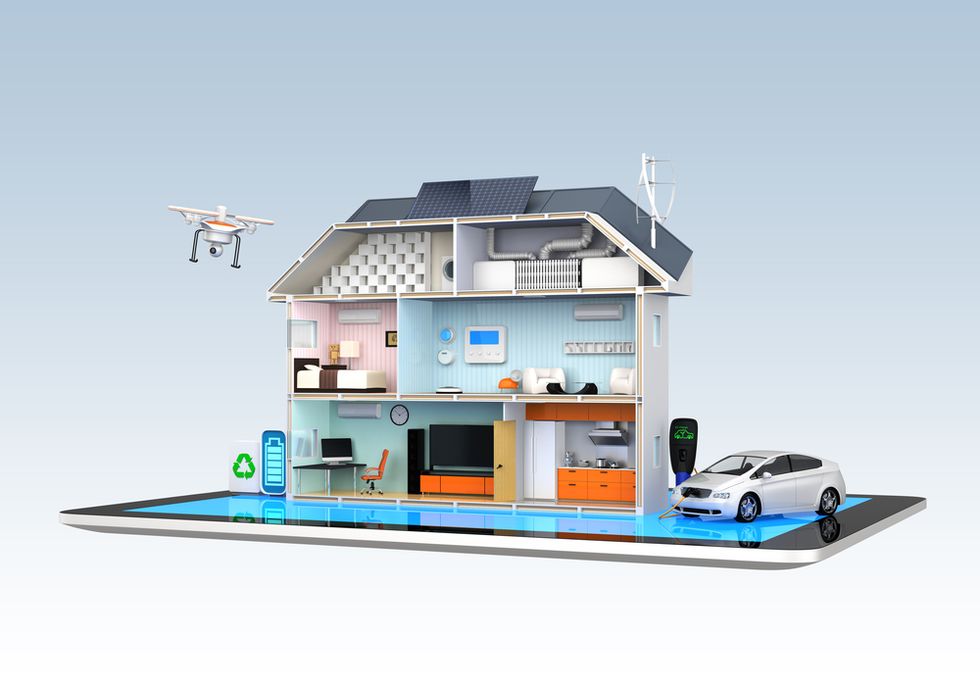 a photo of a model smart home with a drone flying and electric car being charged.