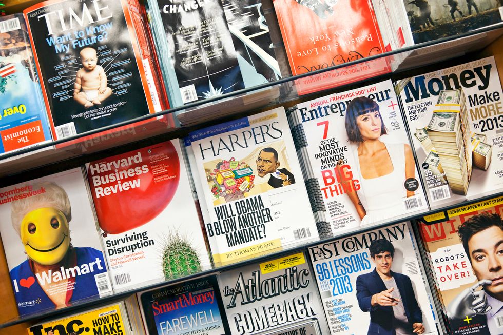 A photo of a newsstand with magazine titles including Time, The Atlantic and Inc.