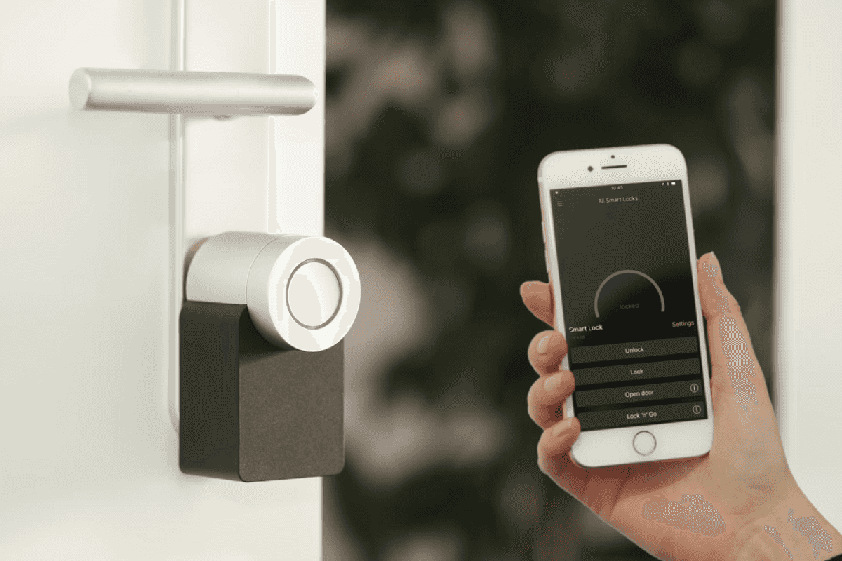 a photo of a Nuki Smart Lock and smartphone using Nuki app to unlock the smart lock.