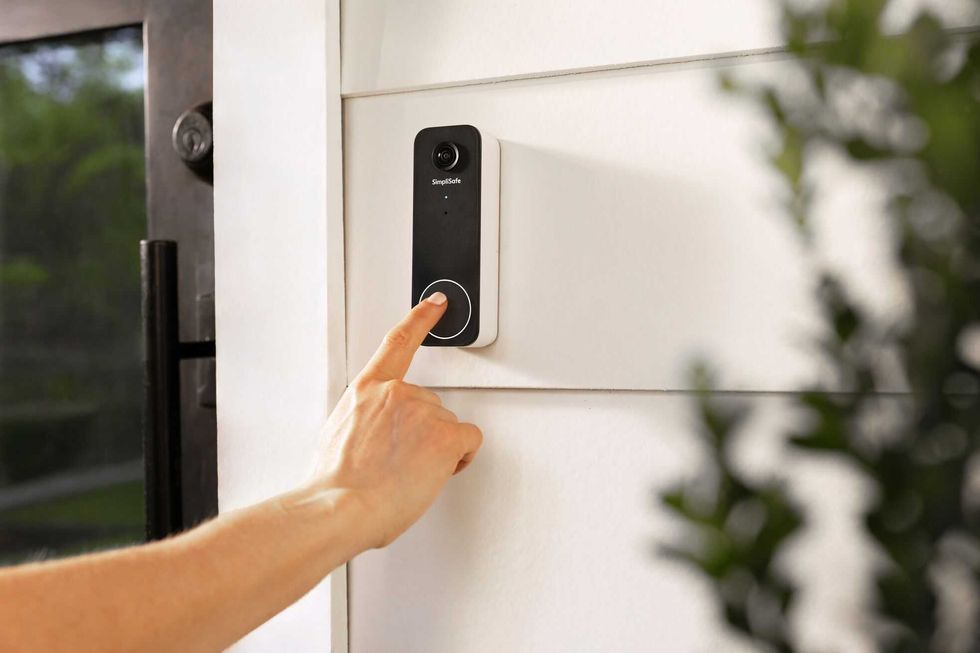 a photo of a person pushing the SimpliSafe Video Doorbell 2