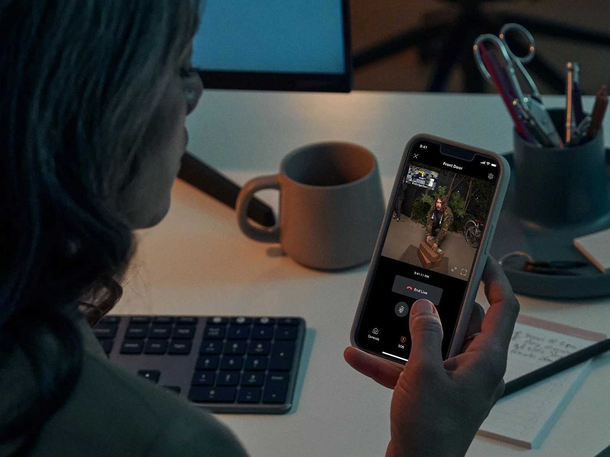 a photo of a person viewing someone at their door during the night time on Ring app.
