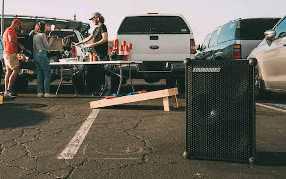 a photo of a tailgate party with Soundboks speaker playing music
