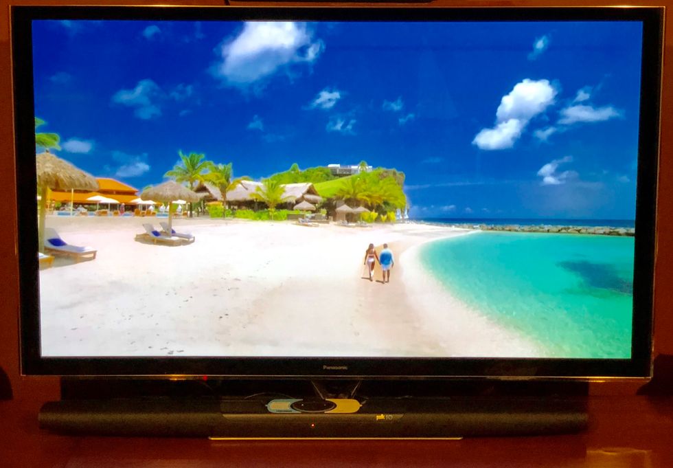 a photo of a tv with Polk soundbar