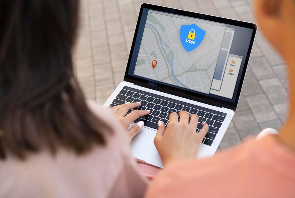 a photo of a woman on a loptop typing.
