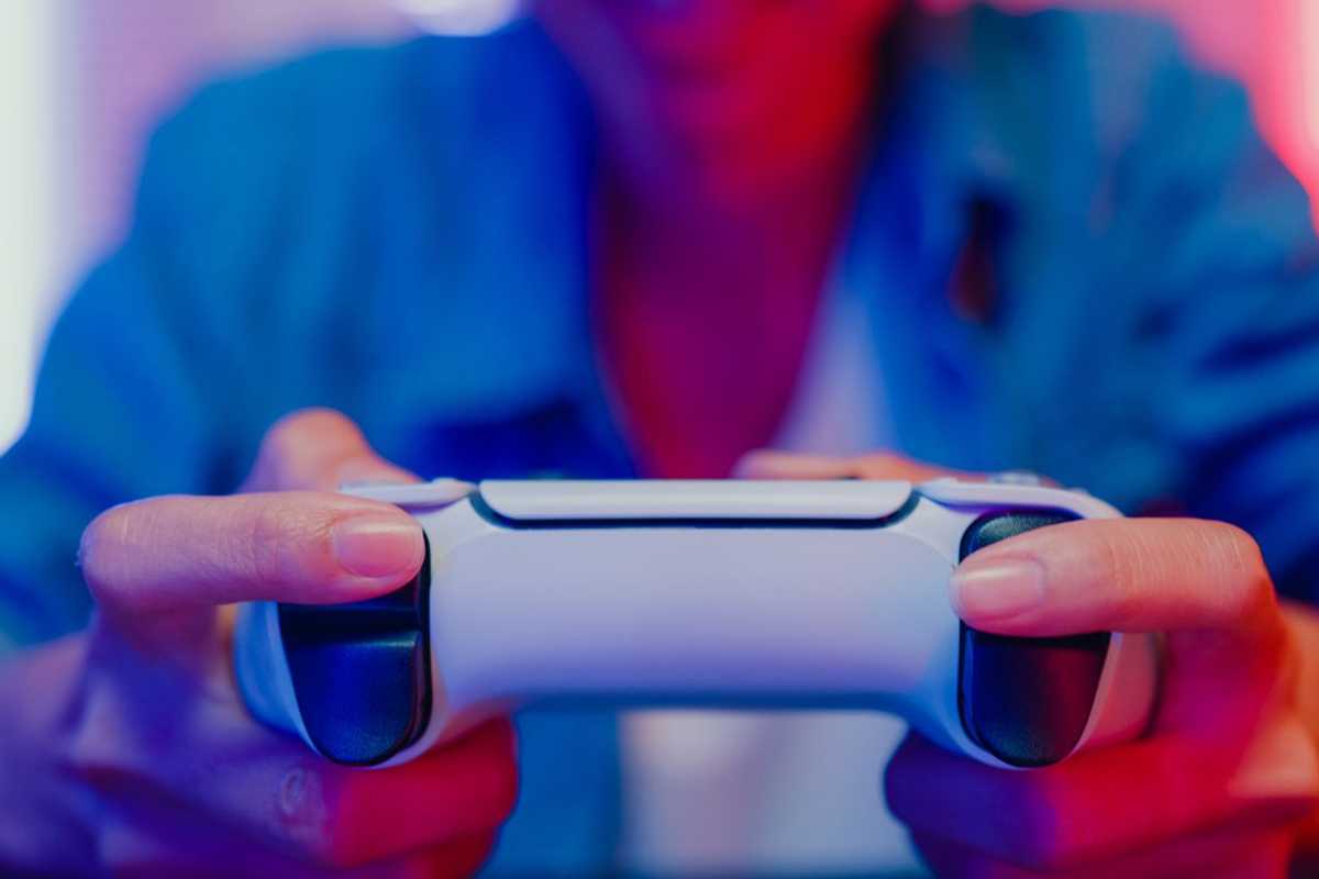 a photo of a woman playing video games holding a game controller