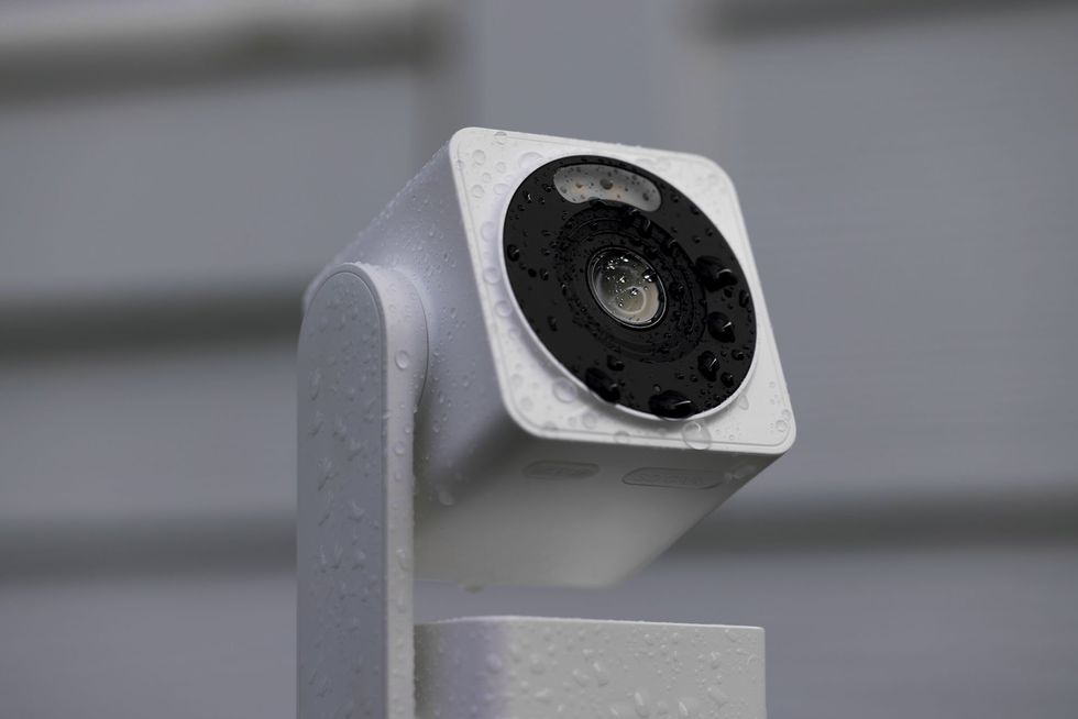 a photo of a Wyze Cam Pan v4 outside in the rain.