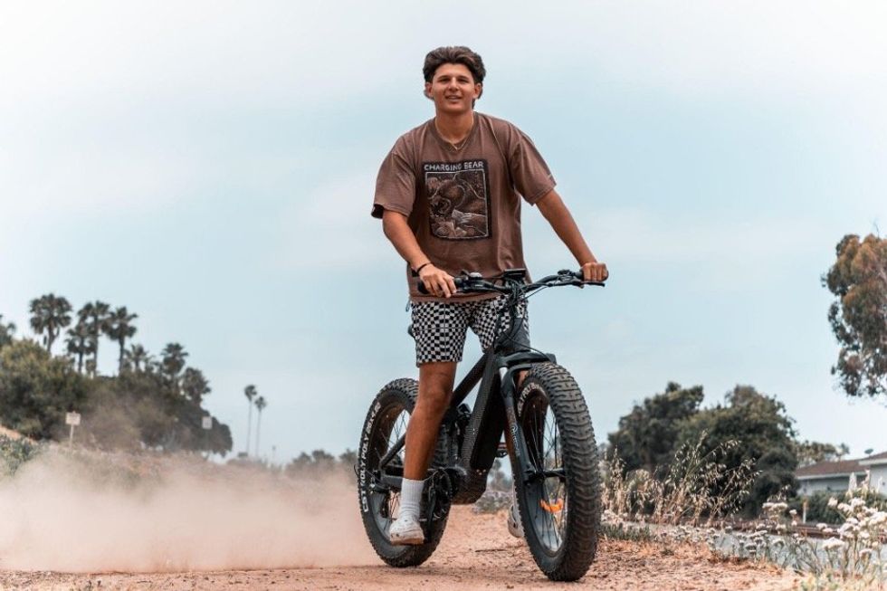 a photo of a young adult riding an e-bike