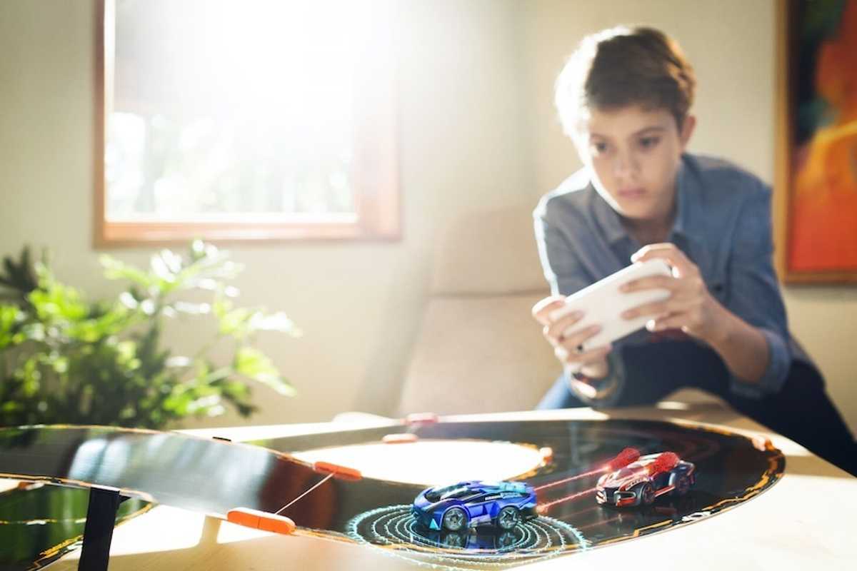 a photo of a young boy playing with remote control cars