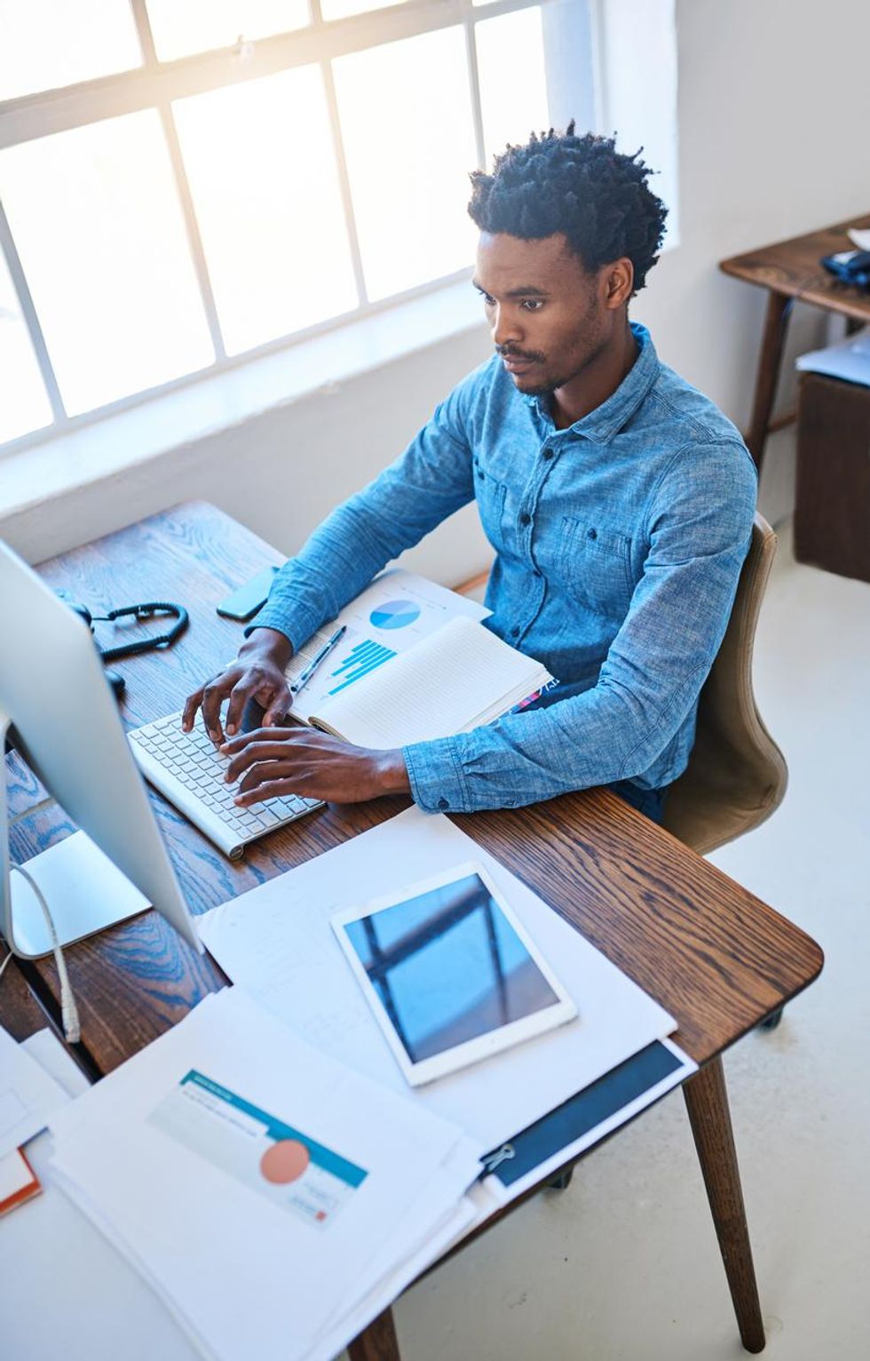 a photo of a young man transcribing a document