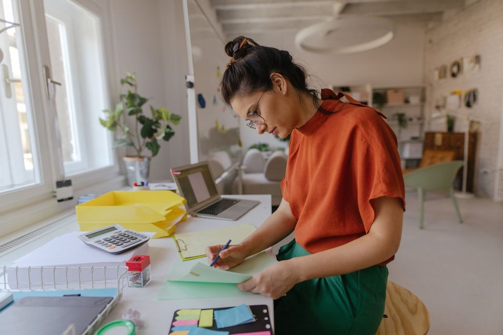a photo of a Young woman working in a modern office