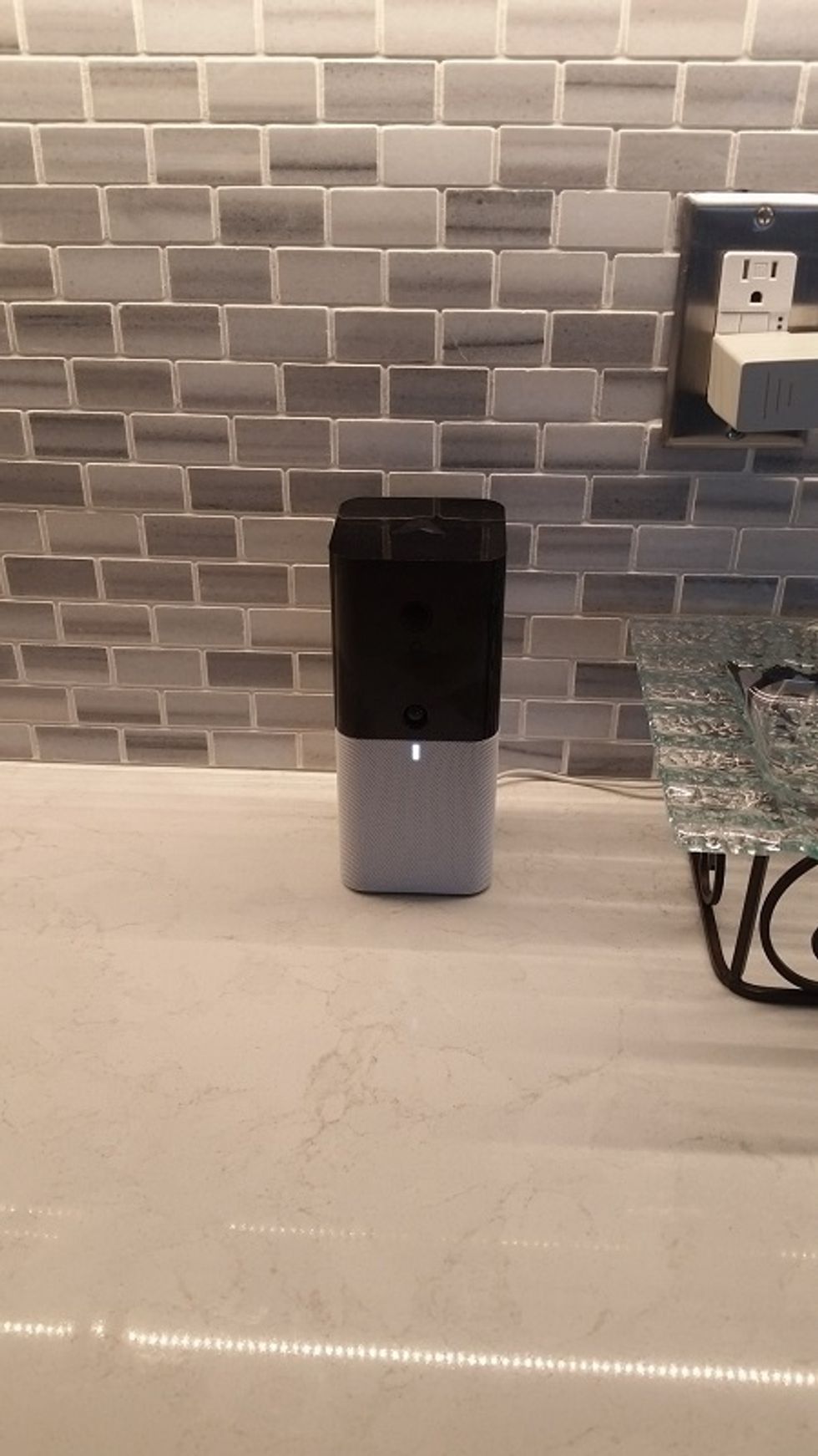 A photo of abode iota hub on a kitchen counter
