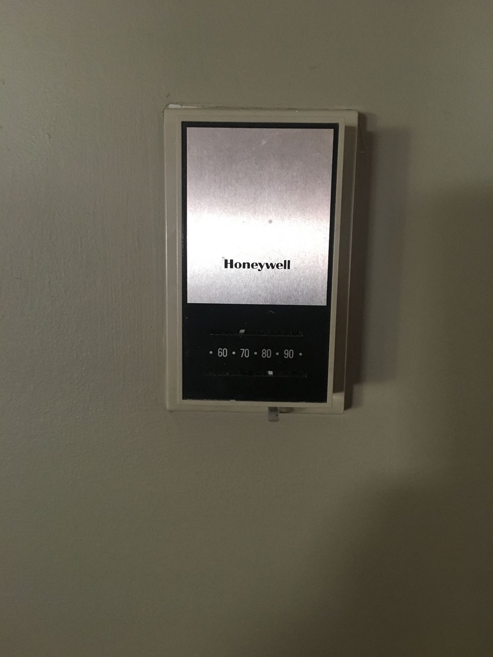 a photo of an old honeywell thermostat on a wall