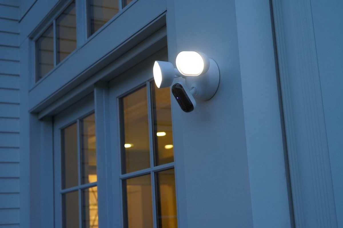 a photo of Arlo Wired Floodlight Camera installed outside on a home at night
