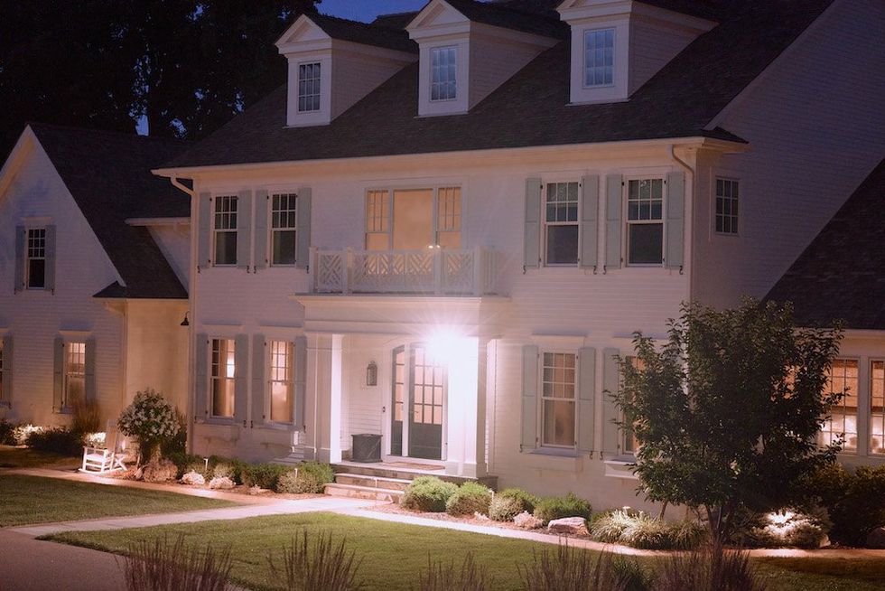 a photo of Arlo Wired Floodlight Camera on the front of a home at night.