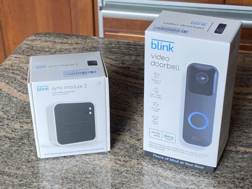 a photo of Blink Video Doorbell and Sync Module 2 boxes on a countertop